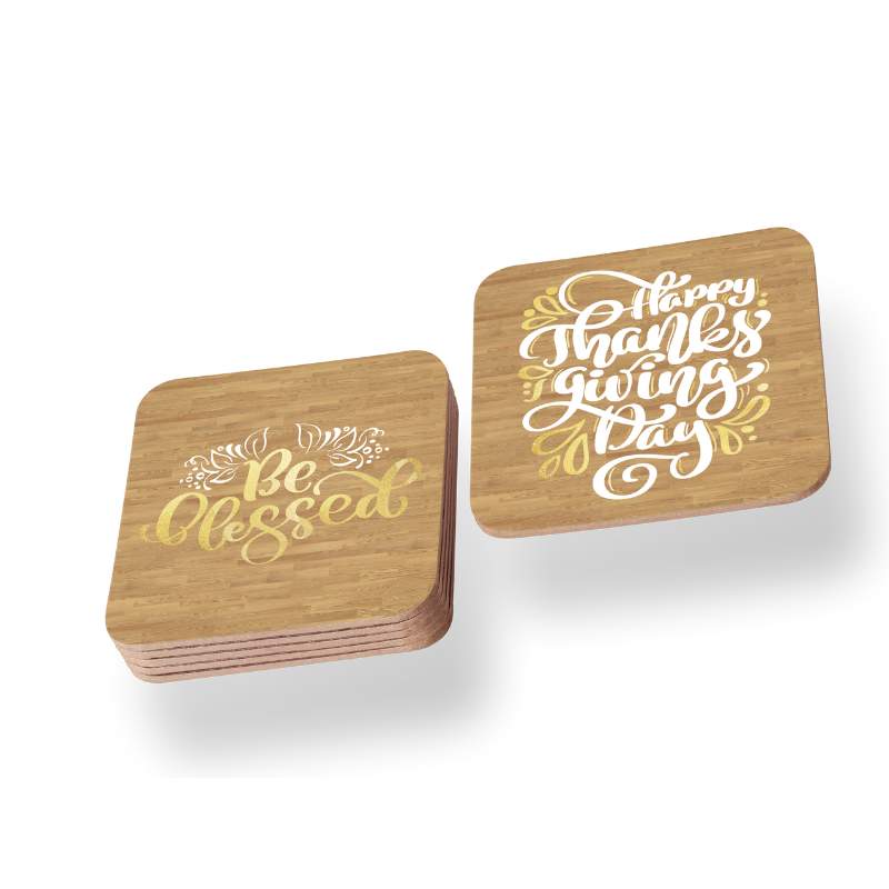 Two wooden coasters with gold text on a white background